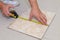 Construction work, worker draws a tile with a pencil