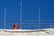 Construction worker adjusting scaffolding on the roof of a building