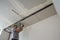 Construction worker assemble a suspended ceiling with drywall an