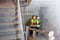 Construction worker and builder inspecting stairs in building shell