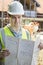 Construction Worker On Building Site Looking At House Plans