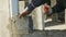 Construction worker builds brick wall, closeup view at construction site