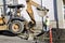 Construction worker bulldozer fixing street