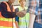 Construction worker and contractor. Client shaking hands with team builder in renovation site