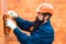 Construction Worker Contractor Man. Orange buid background. Bricklayer industrial worker installing brick masonry. Real