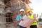 A construction worker control a pouring concrete pump on construction site.