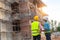 A construction worker control a pouring concrete pump on construction site.