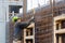 Construction worker controling the level of concrete steel bars outdoors in Nuuk.