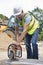 Construction Worker Cutting Stone With Circular Saw