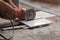 Construction worker cutting a tile using an angle grinder