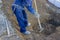 Construction Worker Digging a Deep Underground Hole with a Shove