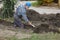 Construction worker digging trench using shovel