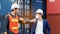 Construction worker or engineer greeting bumping elbows wear safety helmet And mask in the factory Or container. Prevent accidents