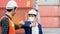 Construction worker or engineer greeting bumping elbows wear safety helmet And mask in the factory Or container. Prevent accidents