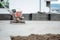 Construction worker finishing concrete screed with power trowel machine, concrete screed smoothing