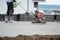 Construction worker finishing concrete screed with power trowel machine, helicopter concrete screed smoothing