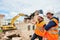 Construction worker and foreman discussing at building site.