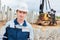 Construction worker foreman in front of pile driver machine