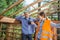 Construction Worker Giving Coffee To Colleague