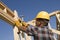 Construction Worker Hammering Nail On Timber Frame