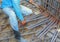 Construction worker hand working installing reinforcement mesh at building site
