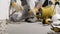 Construction worker hands with gloves working with hammer and chisel to remove old plaster from wall for house renovation, close