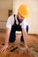 Construction worker and Handyman is removing old wooden parquet flooring using yellow hammer and scraping tool.