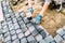 construction worker, handyman using cobblestone granite stones for creating walking path. Terrace or sidewalk details