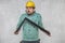 The construction worker is holding a angle in the hand, a guide to constructing right angles