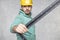 The construction worker is holding a angle in the hand, a guide to constructing right angles