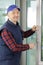 Construction worker holding window glass indoors