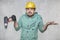 The construction worker holds an electric screwdriver in his hand, various situations