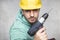 The construction worker holds an electric screwdriver in his hand, various situations