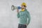 The construction worker holds a megaphone in his hands, the concept of issuing orders