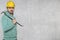 The construction worker holds a work tool in his hands, a crowbar