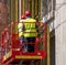 Construction worker on a hydraulic Lift table Platform. Men wearing safety equipment working on a buildin