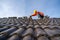 A Construction worker install new roof, Electric drill used on new roofs with Concrete Roof Tiles, Roofing tools