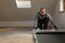 Construction worker installing laminate floor in a new renovated attic. Home improvement concept