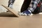 Construction worker installing laminate floor in a new renovated attic. Home improvement concept