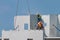 Construction worker are installing the precast concrete wall, orange safety helmet and green vest