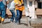 Construction - worker laying and pouring cement or concrete with automatic pump