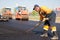 Construction Worker levelling fresh asphalt