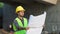 Construction worker looking plans on blueprint