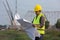 Construction worker looking plans on blueprint