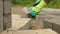 Construction worker makes new sidewalk pavement with stone bricks