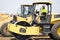 construction worker man used heavy machinery road roller equipment on building industry site for roadwork outdoor