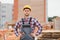 Construction worker man in work clothes and a construction helmet. Portrait of positive male builder in hardhat working