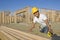 Construction Worker Measuring Planks