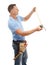 Construction worker, measuring tape and man for maintenance, engineering and building. Manual labor, repair service and