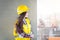 Construction worker pensive girl. Young female engineer looking at a construction site